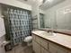 Functional bathroom with a vanity, mirror, and a shower-tub combination with a stylish shower curtain at 7800 Sw 127Th Loop, Ocala, FL 34473