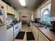 Well-lit kitchen with white appliances, double sink, and convenient access to the dining area at 7800 Sw 127Th Loop, Ocala, FL 34473