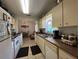 Functional kitchen with white appliances, ample cabinet space, and open view to the dining area at 7800 Sw 127Th Loop, Ocala, FL 34473