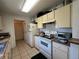 Functional kitchen with white appliances, ample cabinet space, and tile flooring at 7800 Sw 127Th Loop, Ocala, FL 34473
