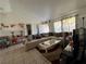 Bright living room featuring a large sectional sofa, decorative pillows, and stylish curtains at 7800 Sw 127Th Loop, Ocala, FL 34473