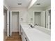 Bright bathroom with long countertop, dual access points, and modern fixtures at 8293 Se 158Th St, Summerfield, FL 34491
