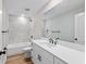 Modern bathroom featuring a large vanity, walk in shower, and white marble style shower at 8293 Se 158Th St, Summerfield, FL 34491