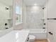 Well-lit bathroom featuring a shower and tub combo with modern tile and sleek fixtures at 8293 Se 158Th St, Summerfield, FL 34491