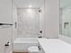 Well-lit bathroom showcasing a tub with a decorative tile surround and a modern vanity at 8293 Se 158Th St, Summerfield, FL 34491