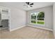 Bedroom featuring neutral tones, a large window, carpet floors, a ceiling fan, and a walk-in closet at 8293 Se 158Th St, Summerfield, FL 34491