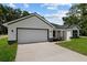 Beautiful single-story home with a two-car garage and a well-maintained driveway at 8293 Se 158Th St, Summerfield, FL 34491