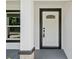 Stylish front door framed with black trim and decorative window accents at 8293 Se 158Th St, Summerfield, FL 34491