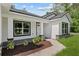 Inviting front exterior with a sidewalk leading to the black trimmed front door at 8293 Se 158Th St, Summerfield, FL 34491