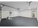 Spacious garage with an epoxy floor, white walls, and an access door to the home at 8293 Se 158Th St, Summerfield, FL 34491