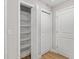 Hallway featuring closet with shelving and a door at 8293 Se 158Th St, Summerfield, FL 34491
