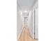 Hallway with wood flooring, recessed lighting, and white doors at 8293 Se 158Th St, Summerfield, FL 34491