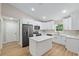 Modern kitchen featuring white cabinets, quartz countertops, and stainless steel appliances at 8293 Se 158Th St, Summerfield, FL 34491