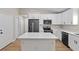 Bright kitchen showcases white cabinetry, stainless appliances, and a center island at 8293 Se 158Th St, Summerfield, FL 34491