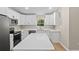 New kitchen boasts white cabinets, quartz counters, and stainless steel appliances at 8293 Se 158Th St, Summerfield, FL 34491