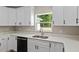 Kitchen details white cabinets, quartz countertop and stainless steel sink at 8293 Se 158Th St, Summerfield, FL 34491