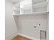 Functional laundry area with storage shelving and modern utility connections at 8293 Se 158Th St, Summerfield, FL 34491