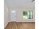 Bright living room with vinyl plank flooring and a welcoming front door at 8293 Se 158Th St, Summerfield, FL 34491