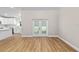 Bright living room with wood floors and white kitchen island at 8293 Se 158Th St, Summerfield, FL 34491