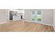 Living room showcasing wood floors and adjacent kitchen and dining area at 8293 Se 158Th St, Summerfield, FL 34491