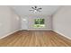 Inviting living room features a ceiling fan and a large window with backyard view at 8293 Se 158Th St, Summerfield, FL 34491