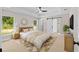 Tranquil main bedroom with tray ceiling, ensuite bathroom, and natural light at 8293 Se 158Th St, Summerfield, FL 34491