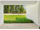 Covered patio area with view of a lush green yard and the border of trees at 8293 Se 158Th St, Summerfield, FL 34491
