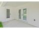 Covered patio area featuring glass double doors to backyard and extra door at 8293 Se 158Th St, Summerfield, FL 34491