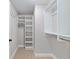 Spacious walk-in closet with built-in organizers, shelves, and rods for optimal storage at 8293 Se 158Th St, Summerfield, FL 34491