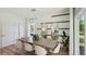 Formal dining room with a large table, stylish chairs, decorative mirrors, and wood-look flooring at 8490 Las Palmas Way, Wildwood, FL 34785