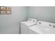 Neat laundry room with a washer and dryer at 8490 Las Palmas Way, Wildwood, FL 34785