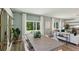 Bright dining area with large windows overlooking the lawn and an open floor plan to the living room at 8510 Las Palmas Way, Wildwood, FL 34785