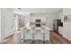 Bright open kitchen with island and seating, stainless appliances and ample storage at 8510 Las Palmas Way, Wildwood, FL 34785