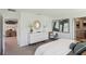 Stylishly decorated main bedroom with a white dresser, unique decor, and an ensuite bathroom at 8510 Las Palmas Way, Wildwood, FL 34785