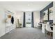 Bright bedroom featuring gray carpet, white walls, large window, stylish decor, and two desk areas for remote work or study at 8518 Las Palmas Way, Wildwood, FL 34785