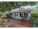 Home exterior featuring a wooden deck, landscaping and green chain link fence at 9001 Sw 91St Cir, Ocala, FL 34481