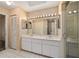 Bathroom featuring a large vanity with dual sinks, ample lighting, and a walk-in shower at 9001 Sw 91St Cir, Ocala, FL 34481