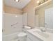 Bright bathroom with tiled floors, tub and shower combo, and single sink vanity at 9001 Sw 91St Cir, Ocala, FL 34481