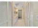Bathroom with white cabinets, dual closets, a tile floor, and a large vanity at 9001 Sw 91St Cir, Ocala, FL 34481