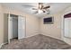 Neutral bedroom featuring a ceiling fan, television, plush carpeting and a closet at 9001 Sw 91St Cir, Ocala, FL 34481