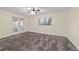 Spacious bedroom features a ceiling fan, neutral tones, large window, and glass doors to screened porch at 9001 Sw 91St Cir, Ocala, FL 34481