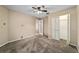 Neutral bedroom featuring a ceiling fan, carpeted floor and closet at 9001 Sw 91St Cir, Ocala, FL 34481