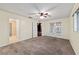 Bedroom featuring tan walls, ceiling fan, and French doors to an enclosed patio at 9001 Sw 91St Cir, Ocala, FL 34481