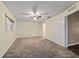 Neutral bedroom with a ceiling fan, neutral colored walls, carpet, and large windows at 9001 Sw 91St Cir, Ocala, FL 34481