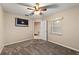 Neutral bedroom featuring a ceiling fan, carpeted floor, television and a window at 9001 Sw 91St Cir, Ocala, FL 34481
