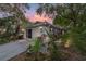 Exterior front view of a single-story home with lush tropical landscaping at 9001 Sw 91St Cir, Ocala, FL 34481