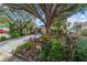 Well-manicured front yard with lush tropical landscaping leading to a charming single-story home at 9001 Sw 91St Cir, Ocala, FL 34481