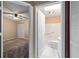 Hallway view into a bathroom with a tub, and a bedroom with a ceiling fan and closet at 9001 Sw 91St Cir, Ocala, FL 34481