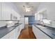 Well-lit kitchen with white cabinets, modern appliances, and hardwood floors at 9001 Sw 91St Cir, Ocala, FL 34481