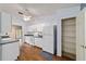 Bright kitchen with white cabinets, matching appliances, and hardwood floors at 9001 Sw 91St Cir, Ocala, FL 34481